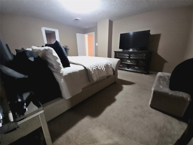 bedroom with a textured ceiling and carpet floors