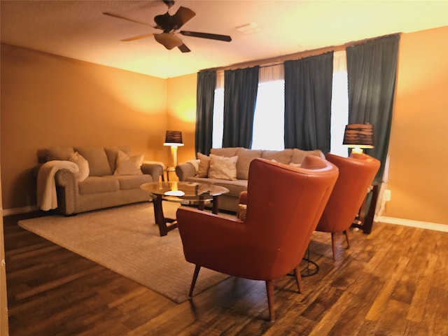 living room featuring ceiling fan and wood-type flooring