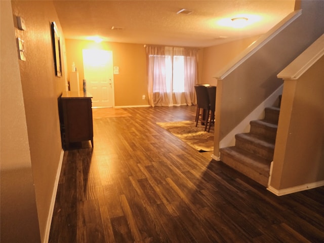 hall with dark hardwood / wood-style flooring