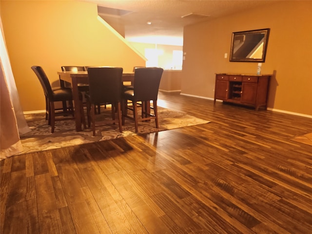 dining space with dark hardwood / wood-style floors