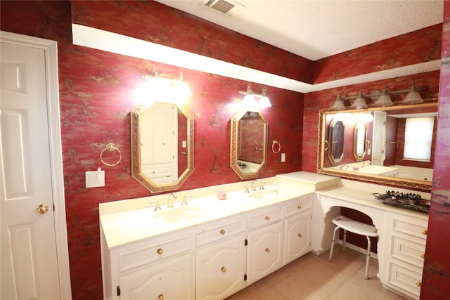 bathroom featuring a textured ceiling, vanity, and tile patterned flooring