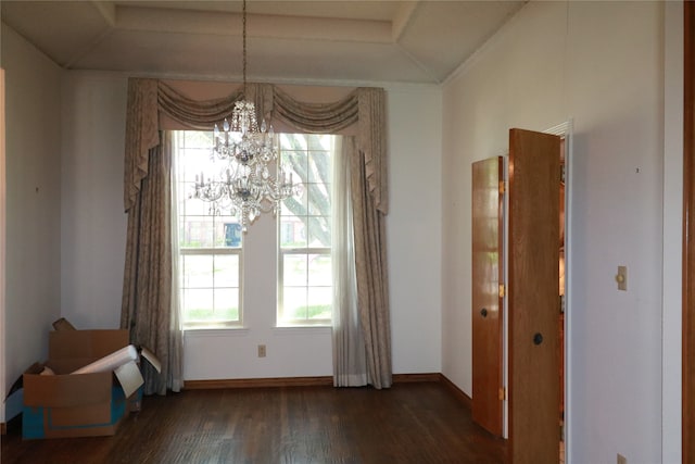 unfurnished dining area featuring dark wood-type flooring and a chandelier