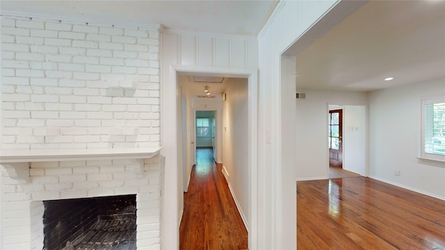 corridor featuring crown molding and hardwood / wood-style floors