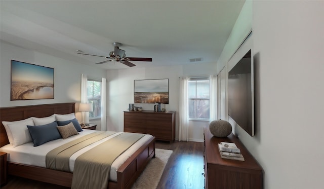 bedroom with ceiling fan and dark hardwood / wood-style flooring