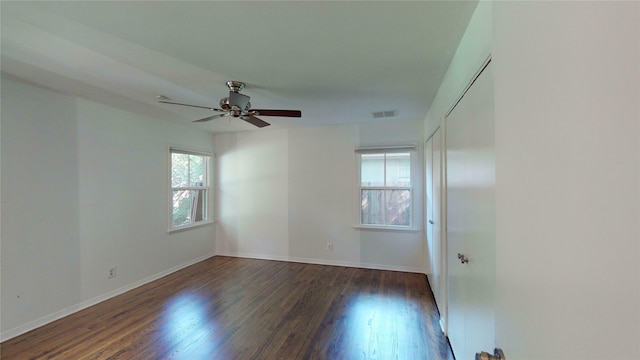 unfurnished room featuring ceiling fan and dark hardwood / wood-style floors