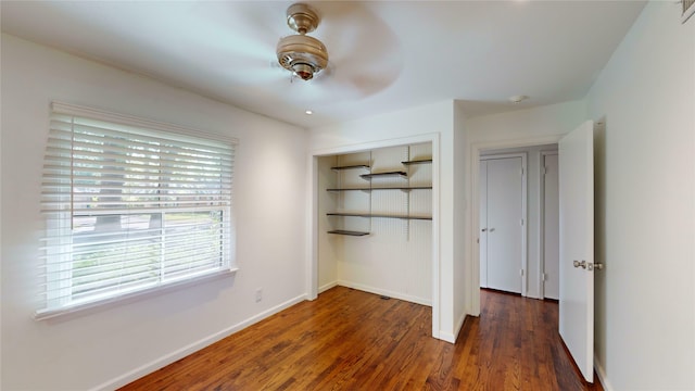 unfurnished bedroom with ceiling fan, dark hardwood / wood-style floors, and a closet