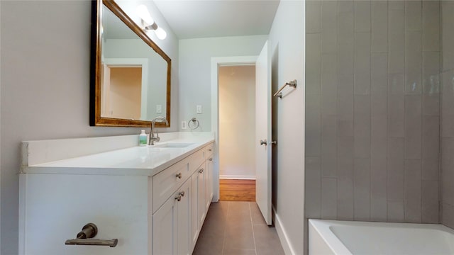 bathroom featuring tile patterned floors, washtub / shower combination, and vanity