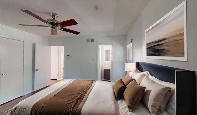 bedroom with ceiling fan, a closet, ensuite bathroom, and hardwood / wood-style floors