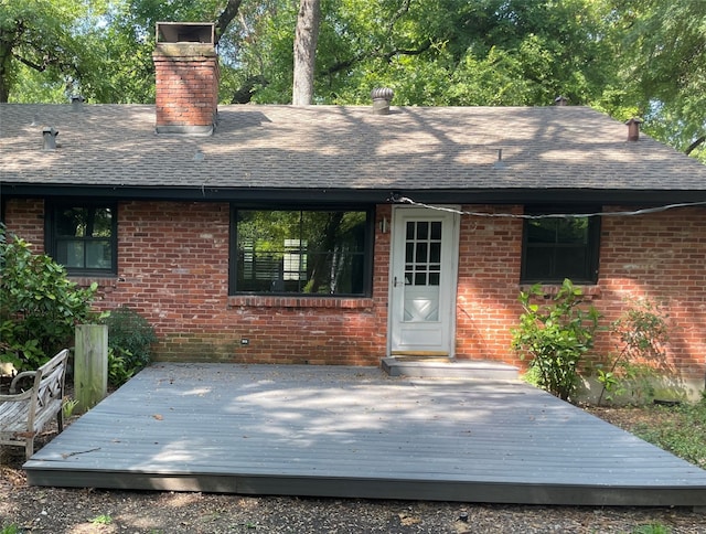 rear view of house featuring a wooden deck