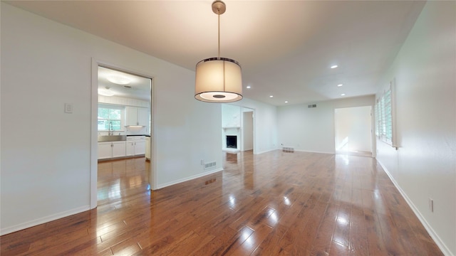 unfurnished living room with wood-type flooring