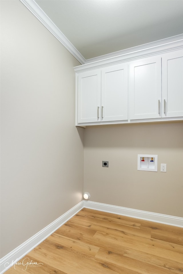 laundry area featuring electric dryer hookup, crown molding, light hardwood / wood-style floors, and hookup for a washing machine