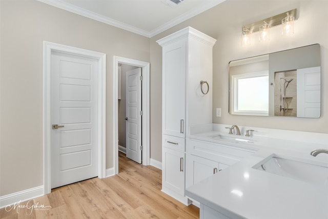 bathroom with double vanity, hardwood / wood-style floors, and ornamental molding