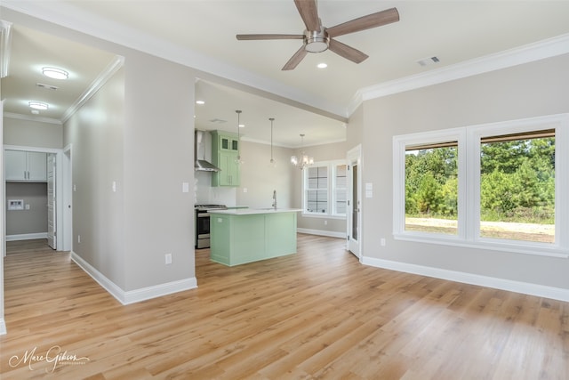 unfurnished living room featuring ceiling fan with notable chandelier, sink, light hardwood / wood-style flooring, and ornamental molding