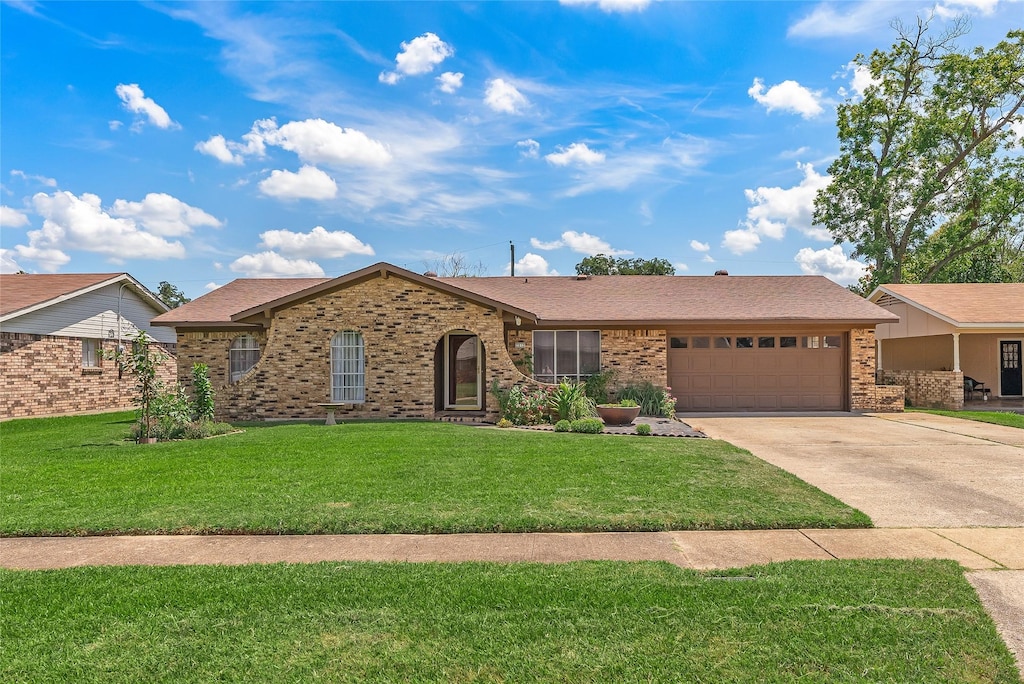 ranch-style house with a front lawn and a garage