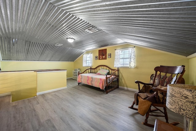 bedroom with lofted ceiling and hardwood / wood-style flooring