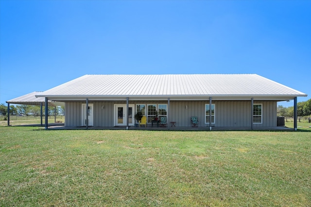 back of property featuring a yard, covered porch, and a carport