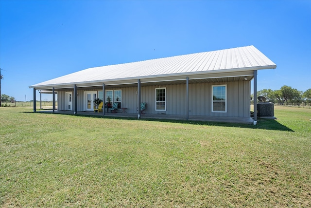 rear view of property featuring a lawn