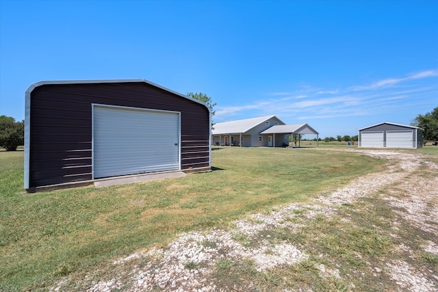 exterior space with a garage and an outbuilding