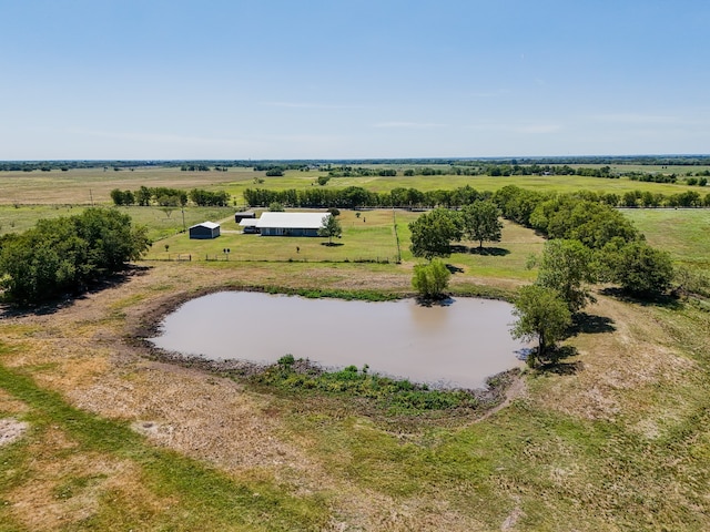 birds eye view of property featuring a water view and a rural view