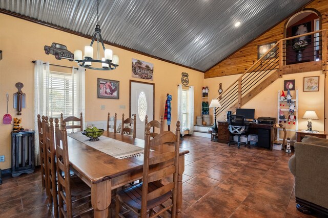 dining space with high vaulted ceiling, a chandelier, and ornamental molding