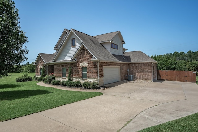 view of front of property with a garage and a front lawn