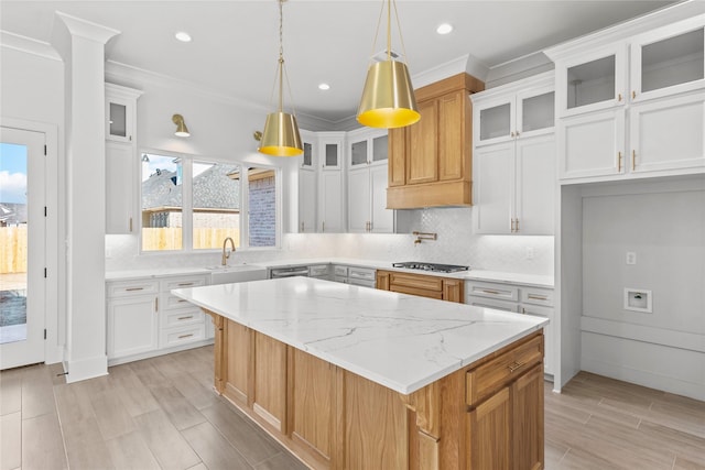 kitchen featuring white cabinets, sink, and a center island