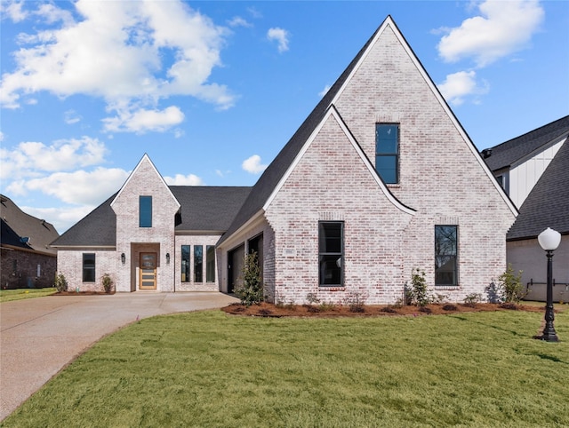 view of front of house with a front yard and a garage