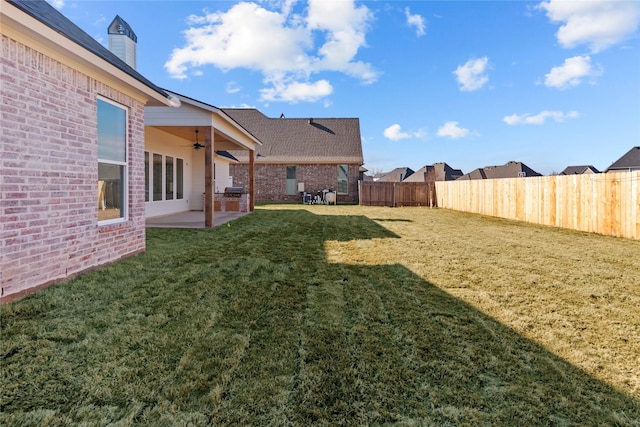 view of yard featuring ceiling fan and a patio area