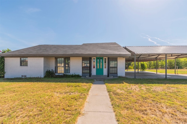 ranch-style home featuring a carport and a front yard