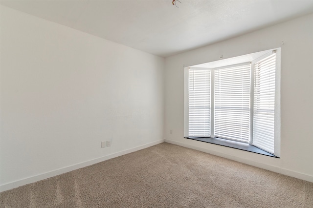 unfurnished room featuring carpet flooring