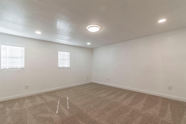 spare room with baseboards, carpet flooring, and recessed lighting