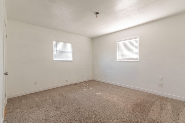 unfurnished room featuring light colored carpet