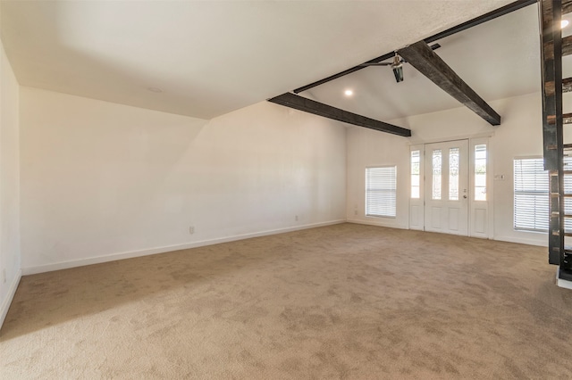 unfurnished room with lofted ceiling with beams and carpet