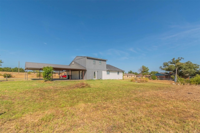 back of house featuring fence and a yard