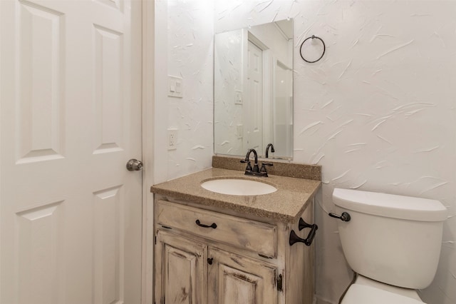 bathroom featuring toilet and vanity