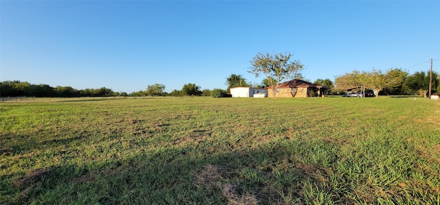 view of yard with a rural view