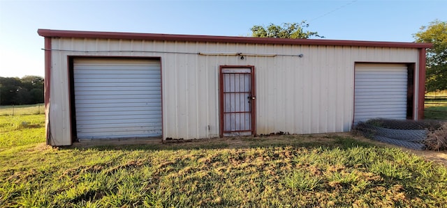 view of outbuilding with a lawn and a garage