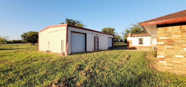 view of outbuilding with a garage and a yard