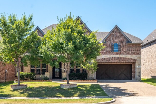 view of front facade featuring a front yard and a garage