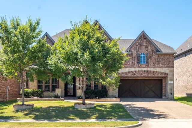 view of front of house with a front yard and a garage