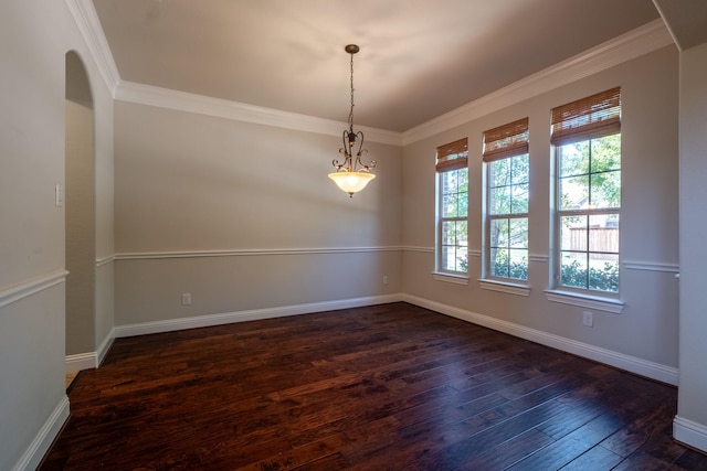 empty room featuring ornamental molding and dark hardwood / wood-style flooring