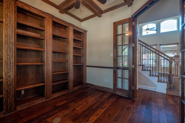 unfurnished office featuring ceiling fan, crown molding, coffered ceiling, dark hardwood / wood-style flooring, and beamed ceiling