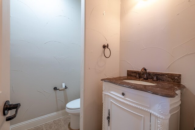 bathroom with tile patterned floors, toilet, and vanity