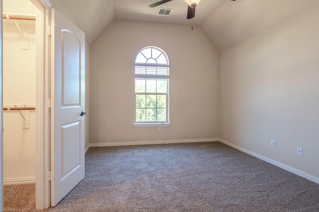 additional living space with ceiling fan, vaulted ceiling, and light colored carpet