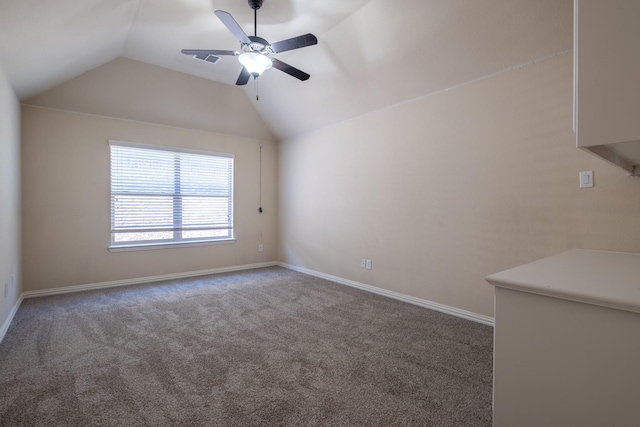 interior space with carpet, vaulted ceiling, and ceiling fan