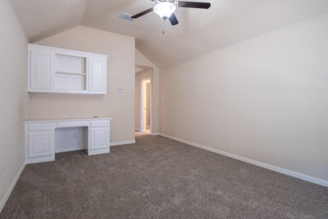 interior space with ceiling fan, vaulted ceiling, and carpet floors