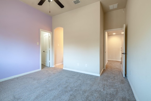 unfurnished bedroom featuring light carpet and ceiling fan