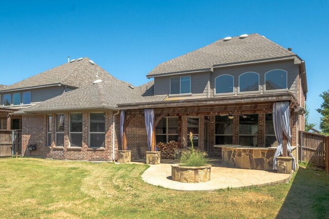 back of house with a patio area and a lawn