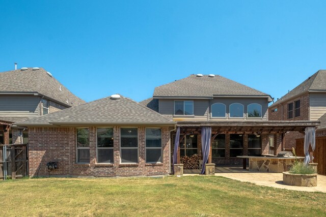 back of property with a patio and a lawn