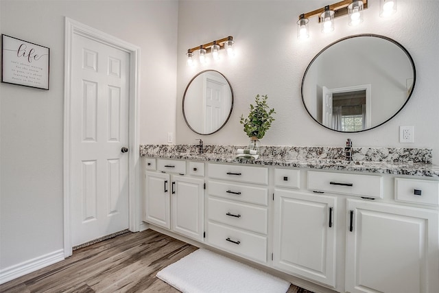 bathroom featuring vanity and wood-type flooring